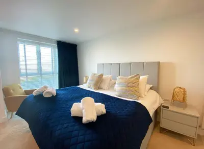 a bedroom with a blue bed with towels on it at 7 Ocean Gate in Newquay