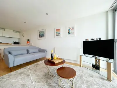 a living room with a couch and a television at 8 Zinc in Newquay