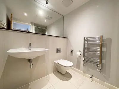 a white bathroom with a sink and a toilet at 8 Zinc in Newquay