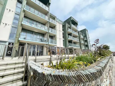 a building with a garden in front of it at 8 Zinc in Newquay