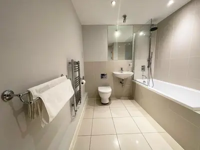 a bathroom with a toilet and a sink and a tub at 8 Zinc in Newquay