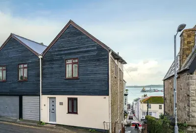 a black and white house on the side of a street at Harbour Steps in Falmouth