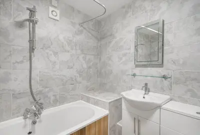 a bathroom with a sink and a bath tub and a sink at Harbour Steps in Falmouth