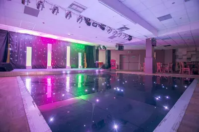 a pool in a room with lights on the floor at Our Lodge at Newquay Bay NB35 in Newquay