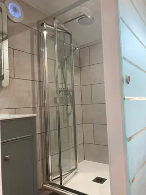 a shower with a glass door in a bathroom at Laity's Lodge in Penzance
