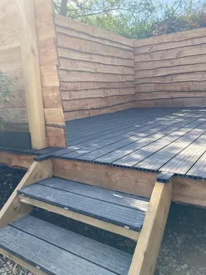 a wooden deck with stairs in a wooden wall at Laity's Lodge in Penzance