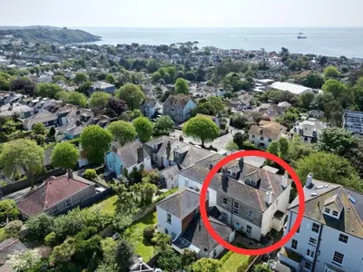 an aerial view of a house in a neighborhood at Pendennis - Bright Victorian flat, sea views & close to beach in Falmouth