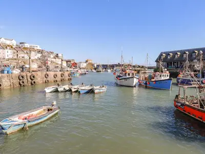 a group of boats are docked in a harbor at Sea View in Mevagissey