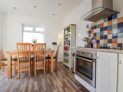 a kitchen with a table and a dining room at Sea View in Mevagissey