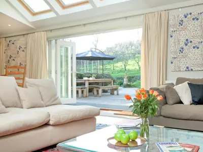 a living room with a couch and a table at The Studio At Granny's Well in Fowey