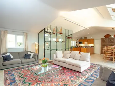a living room with two couches and a table at The Studio At Granny's Well in Fowey