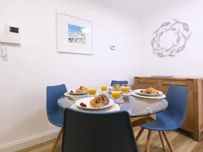 a dining room with a table with plates of food on it at Atlantis in St Ives