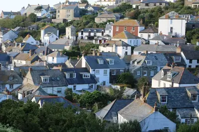 a town with houses and roofs on a hill at Trevan House, Port Isaac Bay Holidays in Port Isaac