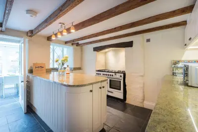 a kitchen with a counter and a stove top oven at Trevan House, Port Isaac Bay Holidays in Port Isaac