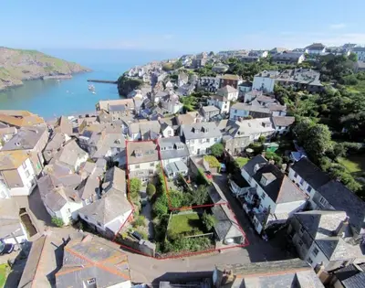 an aerial view of a town with houses and the water at Trevan House, Port Isaac Bay Holidays in Port Isaac