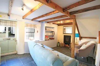 a living room with two blue couches and a fireplace at Trevan House, Port Isaac Bay Holidays in Port Isaac