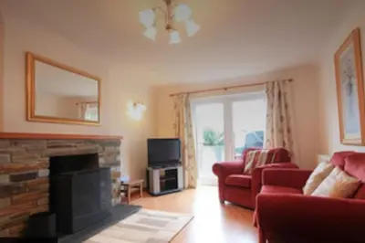 a living room with a couch and a fireplace at Haven Cottage, Port Isaac Bay Holidays in Port Isaac