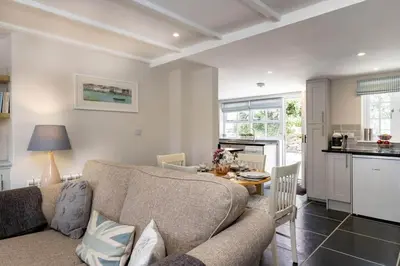 a living room with a couch and a table at Gulls Roost, Port Isaac Bay Holidays in Port Isaac