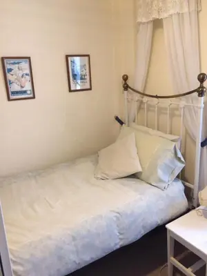a bed with white sheets and pillows in a bedroom at Grey Mullet Guest House in St Ives