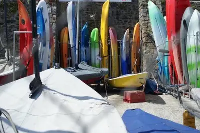 a bunch of surfboards are lined up against a wall at Grey Mullet Guest House in St Ives