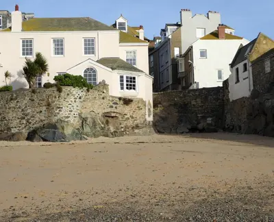 a group of houses and a stone wall at Grey Mullet Guest House in St Ives