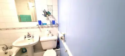 a bathroom with a white toilet and a sink at 9 Wheal Ramoth in Perranporth