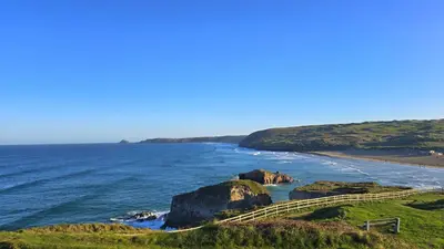 a view of the ocean with a path to a beach at 9 Wheal Ramoth in Perranporth