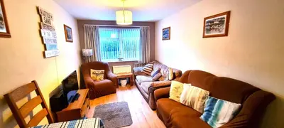 a living room with a couch and two chairs at 9 Wheal Ramoth in Perranporth