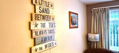 a room with a wall with signs on the wall at 9 Wheal Ramoth in Perranporth