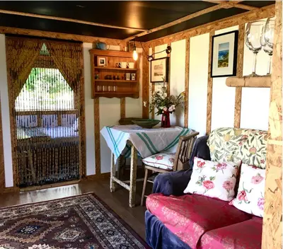 a living room with a table and a couch at Field Hut in Wadebridge