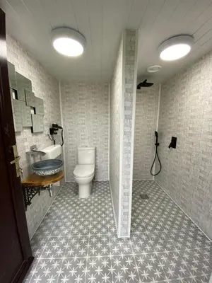 a bathroom with a toilet and a sink at Glamping Dome Elysian Fields in Helston