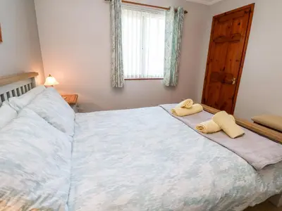 a bedroom with a bed with two towels on it at Salakee in Penzance