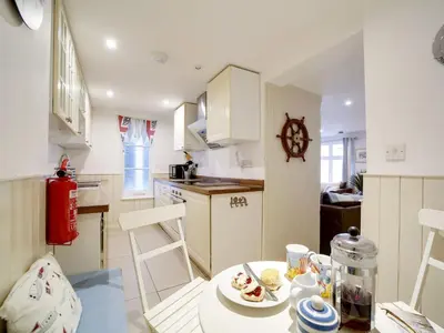 a kitchen with a table with a plate of food on it at Bosuns Locker in Port Isaac