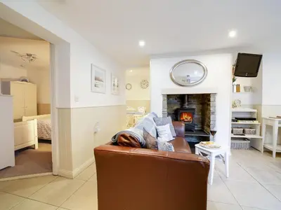 a living room with a couch and a fireplace at Bosuns Locker in Port Isaac