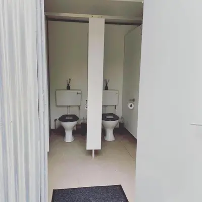 a bathroom with three toilets in a room at Trethowels Grey Hidden hut in St Austell