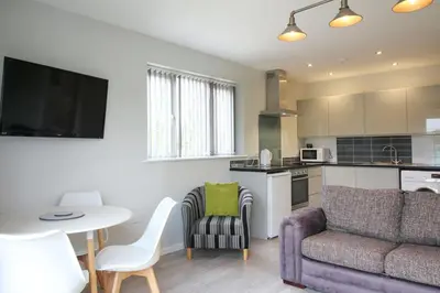 a living room with a couch and a table at Gwel An Koos in Bodmin