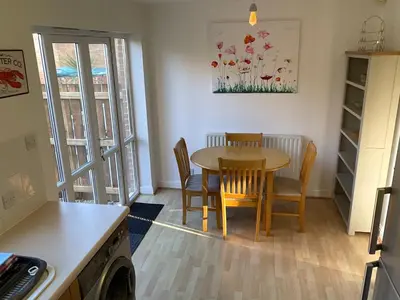a kitchen and dining room with a table and chairs at Newly Renovated 2 Bed house nr Fistral Beach & Gannel Estuary in Newquay