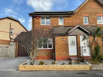 a brick house with a white door at Newly Renovated 2 Bed house nr Fistral Beach & Gannel Estuary in Newquay