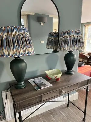 two lamps on a table in a living room at Oystercatcher in Fowey