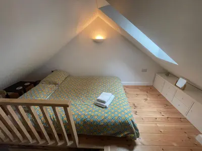 a bedroom with a bed in a attic at Cosy Rustic Annex in quiet Cornwall Village in Saint Wenn