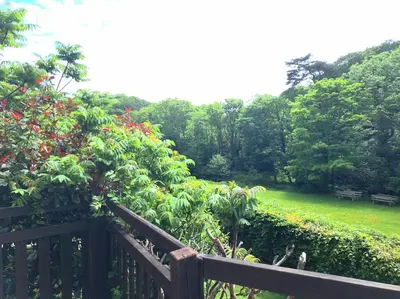a wooden fence in front of a garden with flowers at Rusey Cottage at Crackington Haven, near Bude and Boscastle, Cornwall in Bude