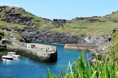 a body of water with a boat in it at Rusey Cottage at Crackington Haven, near Bude and Boscastle, Cornwall in Bude