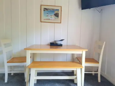 a table with two benches and a bowl on top at Rusey Cottage at Crackington Haven, near Bude and Boscastle, Cornwall in Bude
