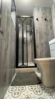 a bathroom with a shower and a toilet at The Lounge in Newquay