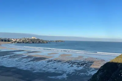 a view of a beach with the ocean and houses at The Lounge in Newquay