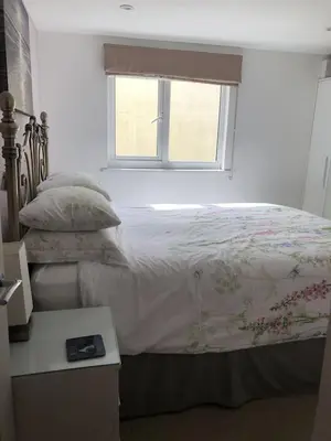 a bedroom with a bed with a window and a table at The Cottage, Cox Hill House, Cox Hill, Chacewater, TR4 8LY in Truro