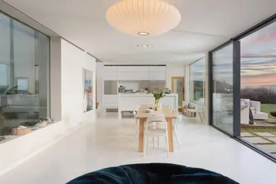 a dining room and living room with a table at Footsteps from the beach - Hot tub - Cosy fireplace in Praa Sands