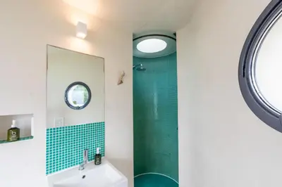 a bathroom with a shower and a sink at Footsteps from the beach - Hot tub - Cosy fireplace in Praa Sands