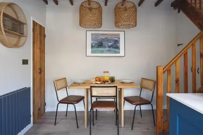 a dining room with a wooden table and chairs at Seascape Hideaways at Port Isaac in Port Isaac