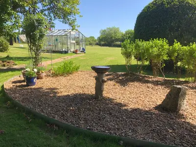 a garden with a bird bath in a yard at Large Family House - sleeps 10. Central Location. 15 mins from coast. in Truro